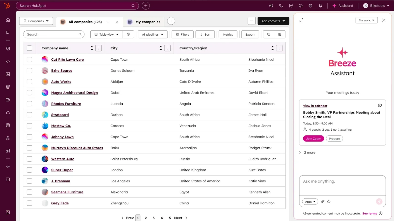 A CRM dashboard displays a list of companies with details like city, country/region, and contacts. On the right, a Breeze Assistant chat panel suggests a partnership meeting—ideal content for your Blog or Newsletter.